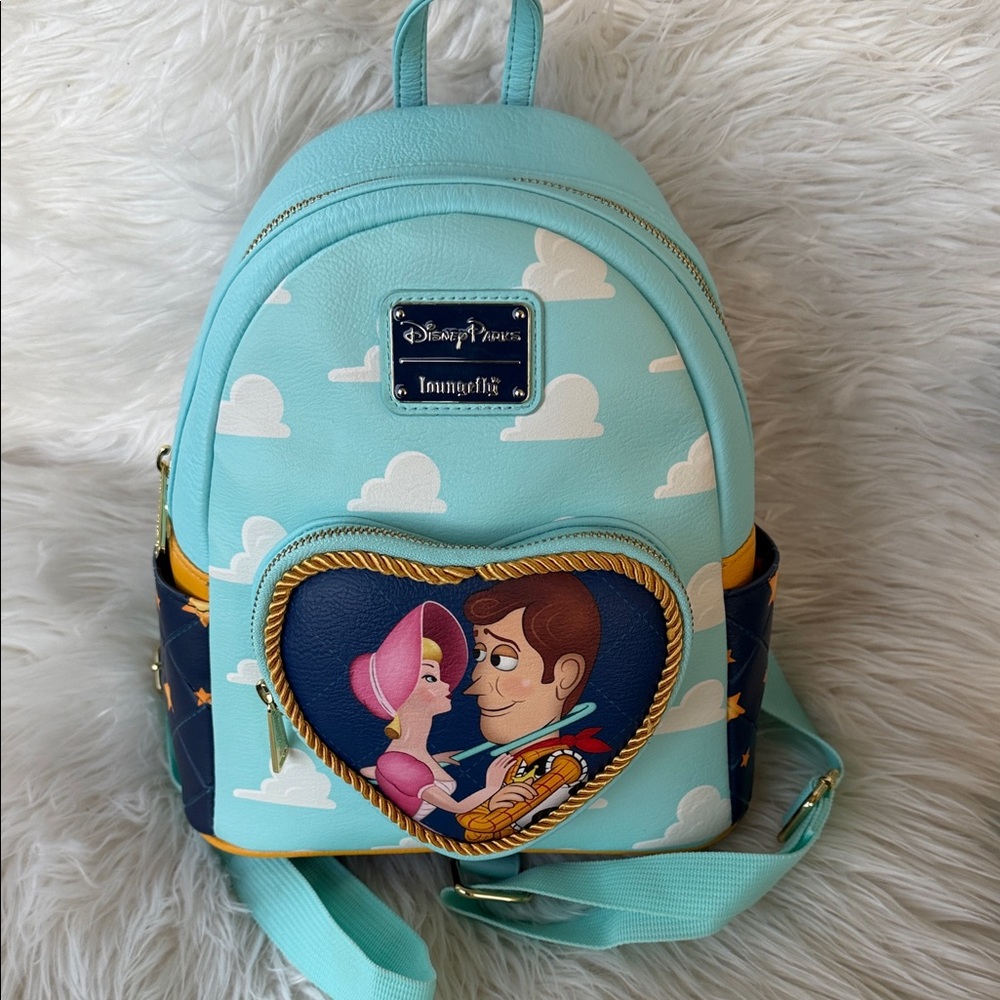 Sold another site Loungefly Toy Story Backpack - Light Blue and Yellow